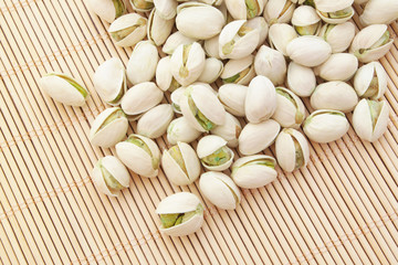 Pistachio nuts on bamboo background