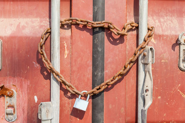 Security and Safety concept, a rusty metal chain and padlock wra