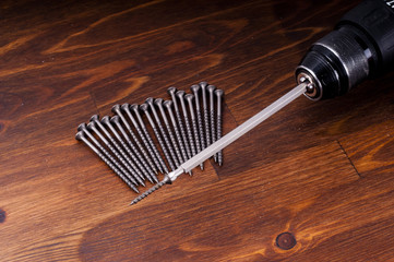 electric screwdriver and screws on the table