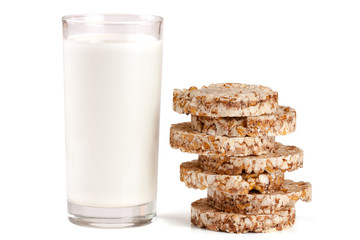 glass of milk with grain crispbreads isolated on white background