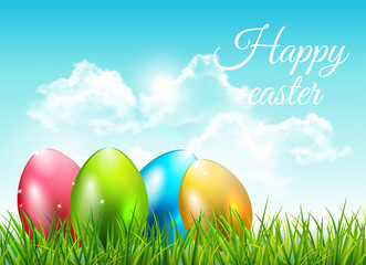 Easter background with eggs in grass and blue sky with clouds