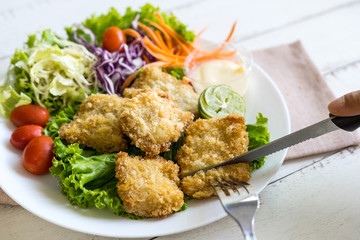 Crispy fried fish fillet with vegetables