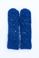 Blue knitted woolen mittens with ornament