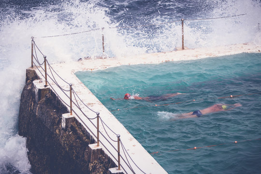 People swimming at an ocean pool