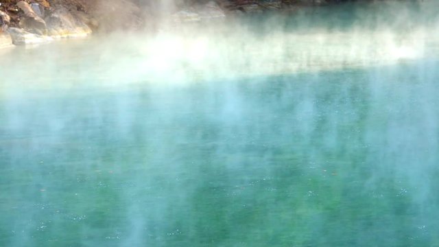 Slow-motion a Bubbling in large hot spring in Taiwan. Pools of hot water in Beitou, Taipei city. Steam Mud Boiling over top of Pond Flood Geyser. Sulphur Caldron From Thermal Spring-Dan