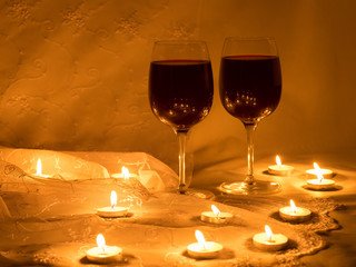 Candles and two glasses of red wine