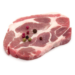 Raw pork neck chop meat with peppercorn spices garnish isolated