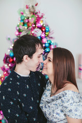young happy couple near a Christmas tree