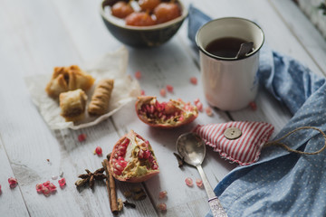 tea, fruit, fabric on wooden background