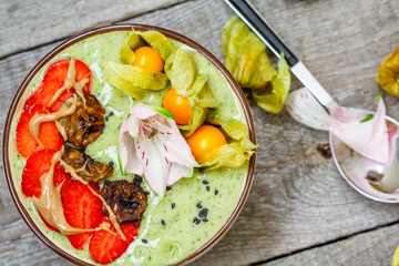 Green banana smoothie bowl with berries. Clean eating, vegetarian, raw, detox, dieting concept