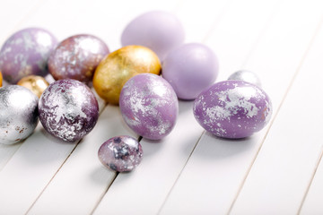 trendy painted Easter eggs on a light background