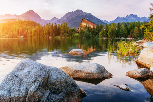 The sunrise over a lake in the park High Tatras. Shtrbske Pleso,