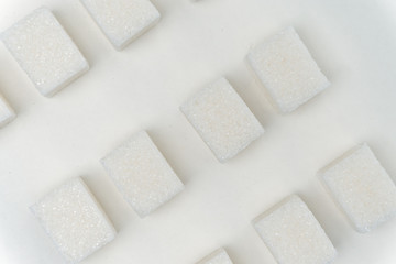 Fototapeta na wymiar cubes of sugar on a light background, ice