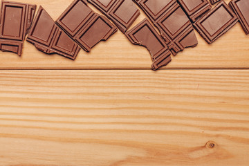 wooden background and broken chocolate bar