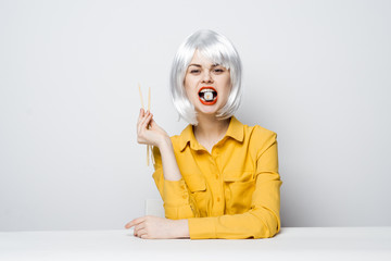 blonde with chopsticks and mouth rolls