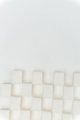 cubes of sugar on a light background, the same order