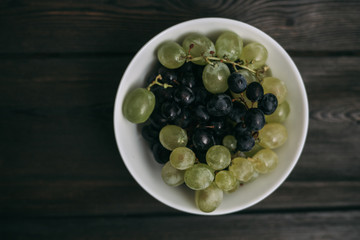 light and dark grapes in a plate