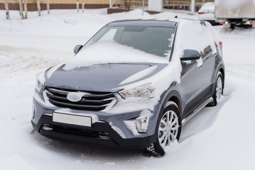 Fototapeta premium Car in the snow after a snowfall