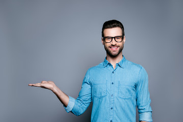 Cheerful bearded man in glasses making advertisement of new prod