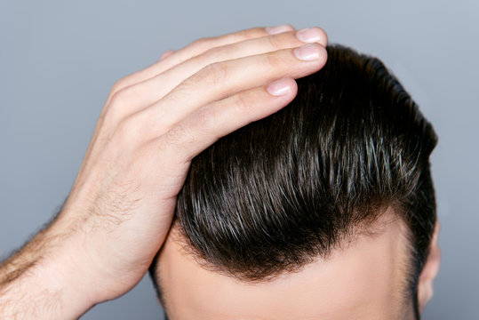 Close up photo of man combing his hair with fingers