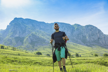 Fototapeta na wymiar Man Hiking in Green Mountains