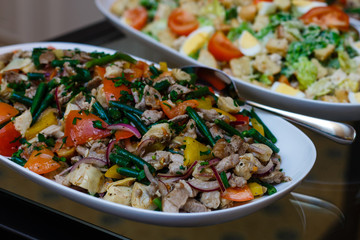 Delicious buffet table at a luxury event spread with a variety of cold meat platters and fresh colorful salad and vegetables