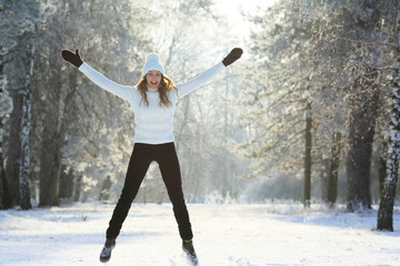 Young happy woman jumping at winter park