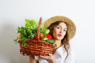 Young woman and organic food - vegetables in the basket