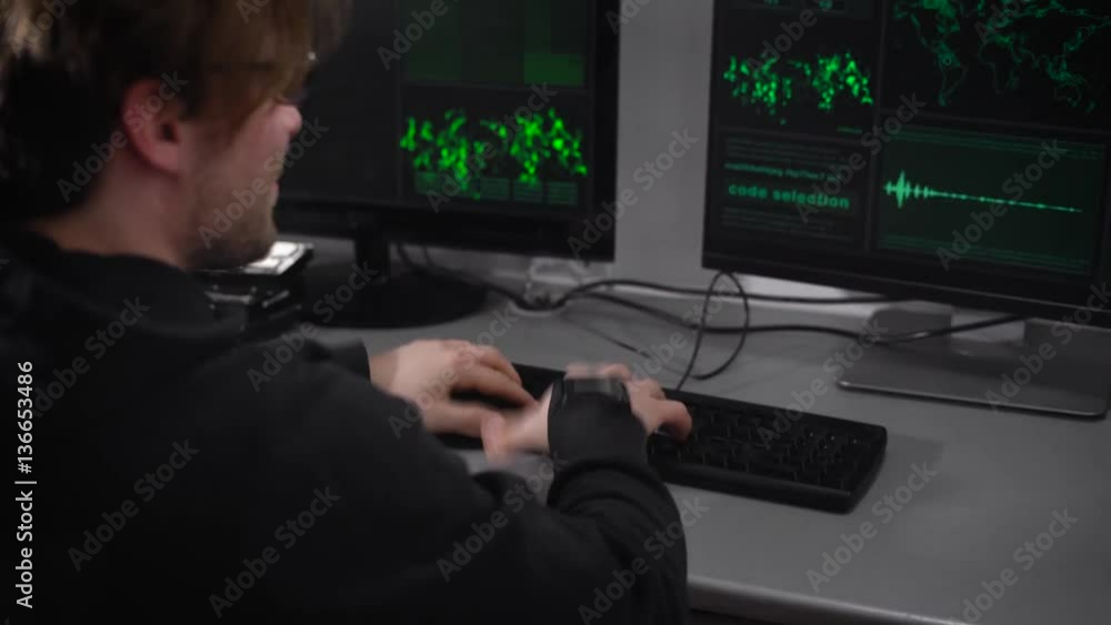 Poster computer room. man on edge. hacker gets nervous hands on the keyboard. the guy is very excited he ca