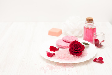 Obraz na płótnie Canvas salt, rose water from rose petals with your hands on a white woo