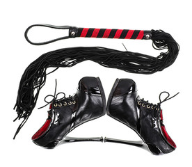 Black leather whip and black shoes for sadomasochism, bondage and domination