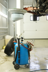 Fototapeta premium Equipment for oil changing in car repair station