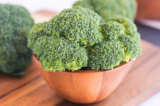 Fresh broccoli in wooden bowl - healthy or vegetarian food conce