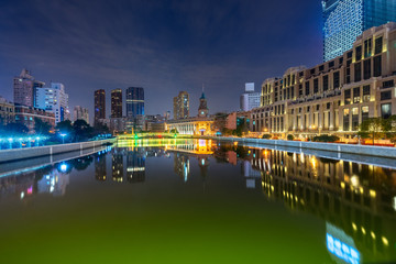 Fototapeta premium River And Modern Buildings Against Sky at night.