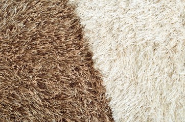Brown and white hairy carpets divide in half