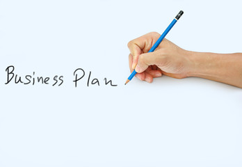 Hand holding a pencil on a white paper background, writing with pencil for word " Business Plan "