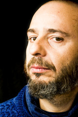 Obraz premium Handsome, bald man with beard on black background