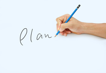 Hand holding a pencil on a white paper background, writing with pencil for word " Plan "