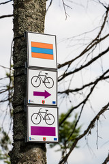 Hiking and cycling trail information sign hanged on tree in Poli