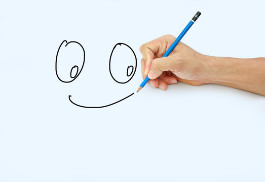 Hand holding a pencil on a white paper background, Drawing with pencil for image of Smile