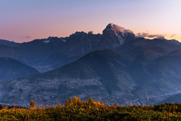 Magic autumn landscape and snow-capped mountain peaks.