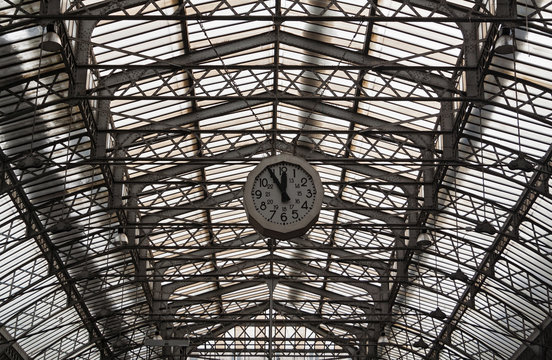 Roof structure of the Paris railway station Gare de l'Est with clock, France