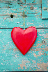 red heart hang on old green wooden wall background