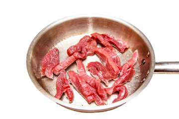 Slices of raw beef are roasted on a steel pan. Insulated.