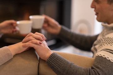 Young couple  in front of fireplace