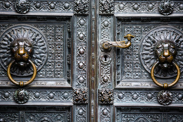 The bronze knocker in the shape of a lion head from the gate of the Cologne Cathedral in Germany