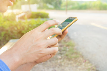 Man uses his Mobile Phone outdoor, close up
