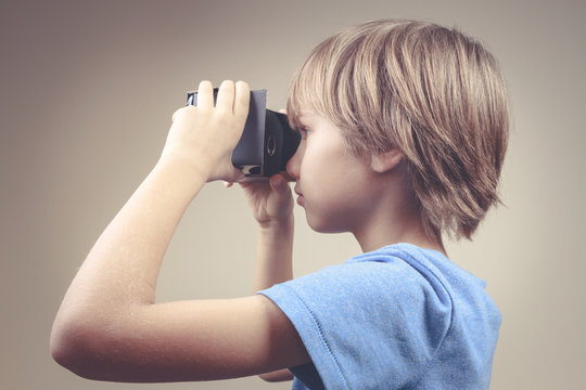 Child Using New Virtual Reality, VR Cardboard Glasses