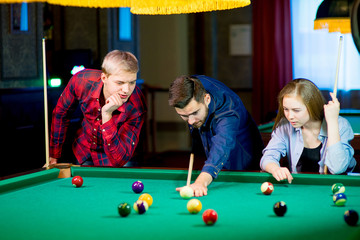 friends playing billiard