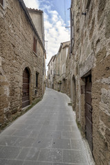 Fototapeta na wymiar A typical narrow alley in the historic center of Pitigliano, Grosseto, Tuscany, Italy